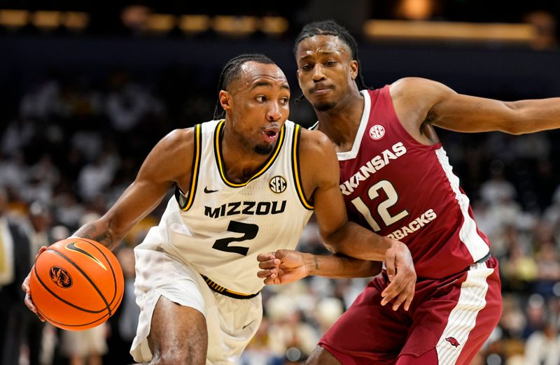 sJan 31, 2024; Columbia, Missouri, USA; Missouri Tigers guard Tamar Bates (2) drives against Arkansas Razorbacks guard Tramon Mark (12) during the first half at Mizzou Arena. Mandatory Credit: Jay Biggerstaff-USA TODAY Sports