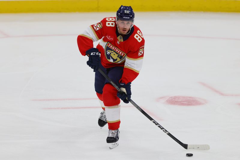 Nov 12, 2024; Sunrise, Florida, USA; Florida Panthers defenseman Nate Schmidt (88) moves the puck against the New Jersey Devils during the third period at Amerant Bank Arena. Mandatory Credit: Sam Navarro-Imagn Images