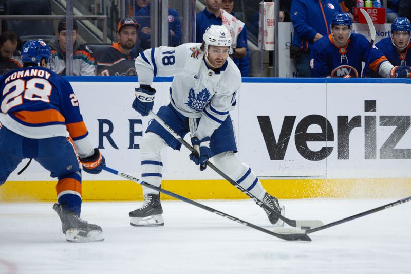 Dec 11, 2023; Elmont, New York, USA; Toronto Maple Leafs center Noah Gregor (18) looks to make a pass against the New York Islanders during the first period at UBS Arena. Mandatory Credit: Thomas Salus-USA TODAY Sports