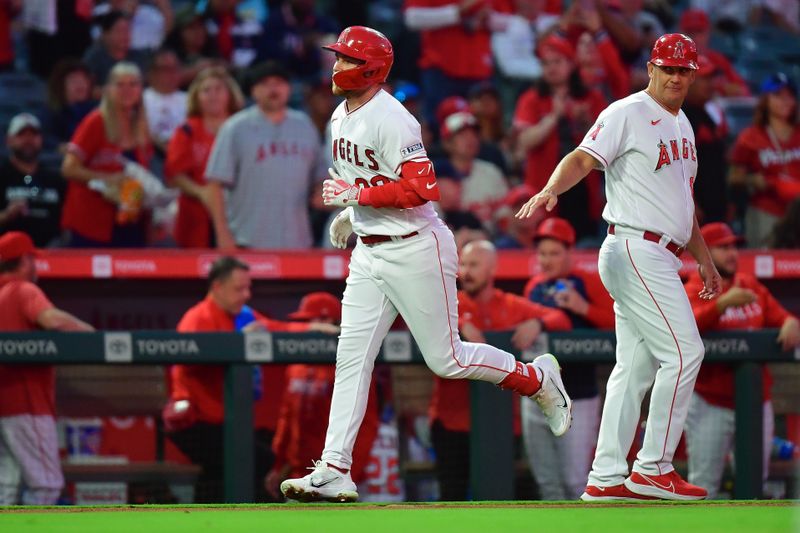 Sep 26, 2023; Anaheim, California, USA; Los Angeles Angels first baseman Brandon Drury (23) is greeted by third base coach Bill Haselman (82) after hitting a three run home run against the Texas Rangers during the first inning at Angel Stadium. Mandatory Credit: Gary A. Vasquez-USA TODAY Sports