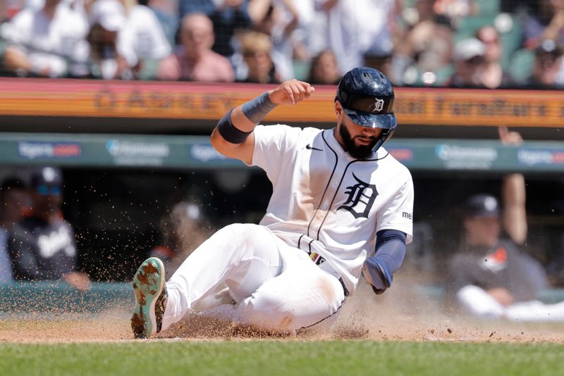 May 25, 2025; Detroit, Michigan, USA;  Detroit Tigers second base Gleyber Torres (25) slides in safe at home in the fourth inning against the Cleveland Guardians at Comerica Park. Mandatory Credit: Rick Osentoski-Imagn Images