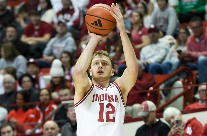 Nov 29, 2025; Bloomington, Indiana, USA; Indiana Hoosiers forward Tucker Devries (12) shoots the ball during the first half against the Bethune-Cookman Wildcats at Simon Skjodt Assembly Hall. Mandatory Credit: Robert Goddin-Imagn Images