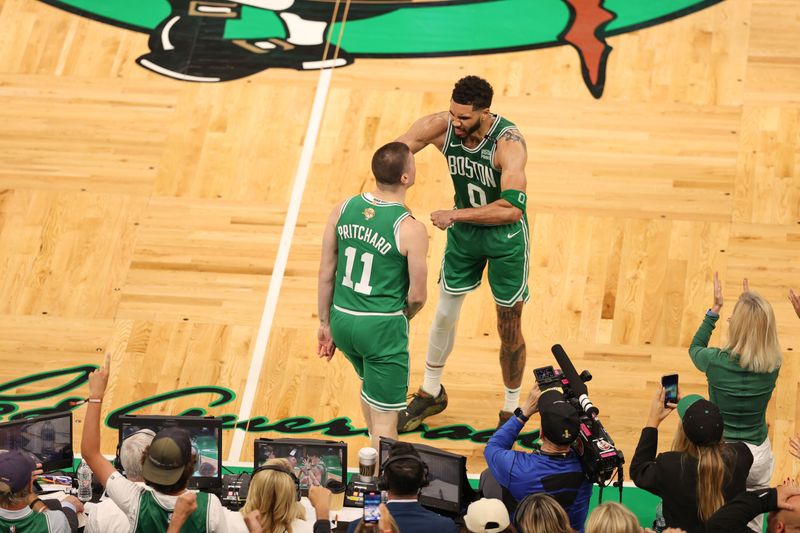 BOSTON, MA - JUNE 17: Payton Pritchard #11 of the Boston Celtics and Jayson Tatum #0 of the Boston Celtics celebrate during the game against the Dallas Mavericks during Game 5 of the 2024 NBA Finals on June 17, 2024 at the TD Garden in Boston, Massachusetts. NOTE TO USER: User expressly acknowledges and agrees that, by downloading and or using this photograph, User is consenting to the terms and conditions of the Getty Images License Agreement. Mandatory Copyright Notice: Copyright 2024 NBAE  (Photo by Stephen Gosling/NBAE via Getty Images)