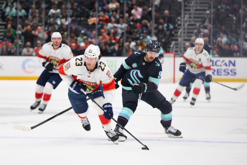 Mar 15, 2026; Seattle, Washington, USA; Florida Panthers center Carter Verhaeghe (23) advances the puck while defended by Seattle Kraken center Chandler Stephenson (9) during the third period at Climate Pledge Arena. Mandatory Credit: Steven Bisig-Imagn Images