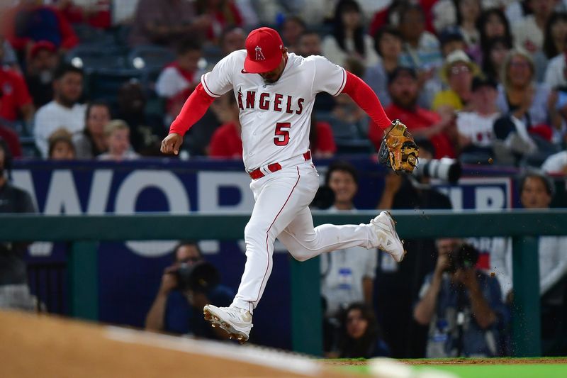 Sep 5, 2023; Anaheim, California, USA; Los Angeles Angels third baseman Eduardo Escobar (5) tags third for the out against Baltimore Orioles shortstop Jorge Mateo (3) during the seventh inning at Angel Stadium. Mandatory Credit: Gary A. Vasquez-USA TODAY Sports