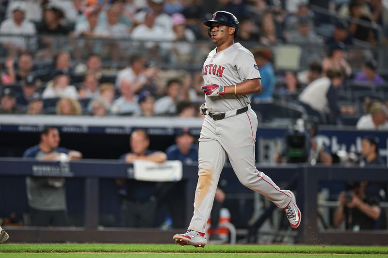 Jul 7, 2024; Bronx, New York, USA; Boston Red Sox third baseman Rafael Devers (11) scores after his solo home run during the seventh inning against the New York Yankees at Yankee Stadium. Mandatory Credit: Vincent Carchietta-USA TODAY Sports