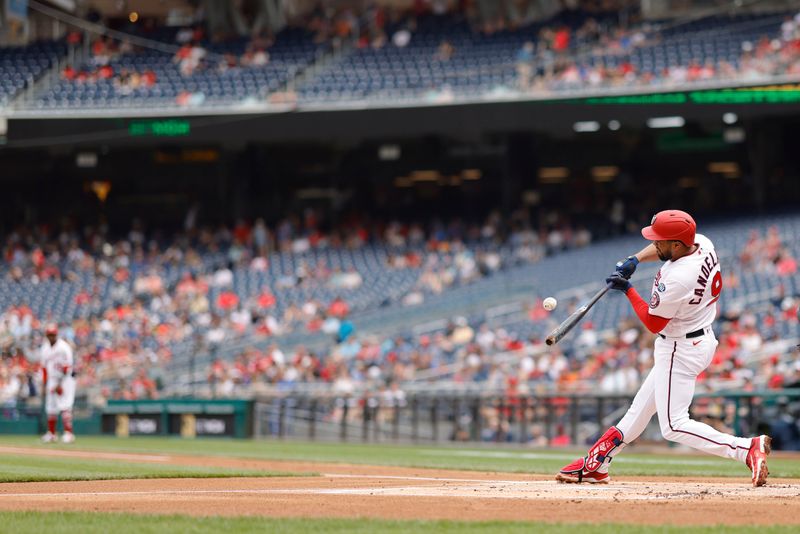 Apr 16, 2023; Washington, District of Columbia, USA; Washington Nationals third baseman Jeimer Candelario (9) hits an RBI single against the Cleveland Guardians during the first inning at Nationals Park. Mandatory Credit: Geoff Burke-USA TODAY Sports