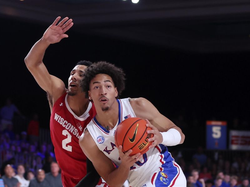 Nov 24, 2022; Paradise Island, BAHAMAS; Kansas Jayhawks forward Jalen Wilson (10) passes the ball as Wisconsin Badgers guard Jordan Davis (2) defends during the first half at Imperial Arena. Mandatory Credit: Kevin Jairaj-USA TODAY Sports