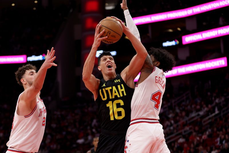 HOUSTON, TEXAS - JANUARY 20: Simone Fontecchio #16 of the Utah Jazz shoots the ball while defended by Jalen Green #4 of the Houston Rockets and Alperen Sengun #28 in the second half at Toyota Center on January 20, 2024 in Houston, Texas.  NOTE TO USER: User expressly acknowledges and agrees that, by downloading and or using this photograph, User is consenting to the terms and conditions of the Getty Images License Agreement. (Photo by Tim Warner/Getty Images)