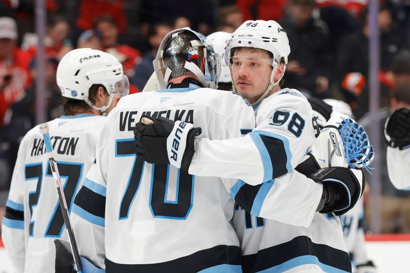 Mar 3, 2026; Washington, District of Columbia, USA; Utah Mammoth goalie Karel Vejmelka (70) celebrates with Mammoth defenseman Mikhail Sergachev (98) after defeating the Washington Capitals at Capital One Arena. Mandatory Credit: Amber Searls-Imagn Images
