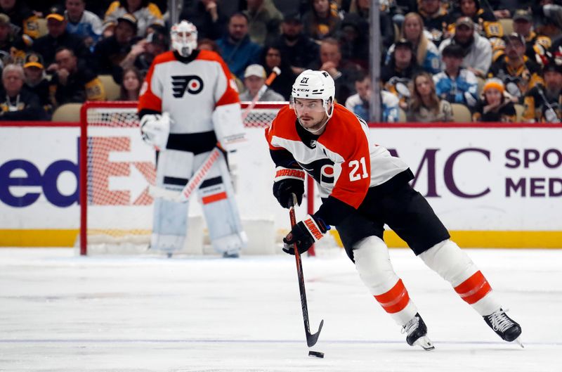 Feb 25, 2024; Pittsburgh, Pennsylvania, USA;  Philadelphia Flyers center Scott Laughton (21) skates spice with the puck against the Pittsburgh Penguins during the third period at PPG Paints Arena.  Pittsburgh won 7-6. Mandatory Credit: Charles LeClaire-USA TODAY Sports