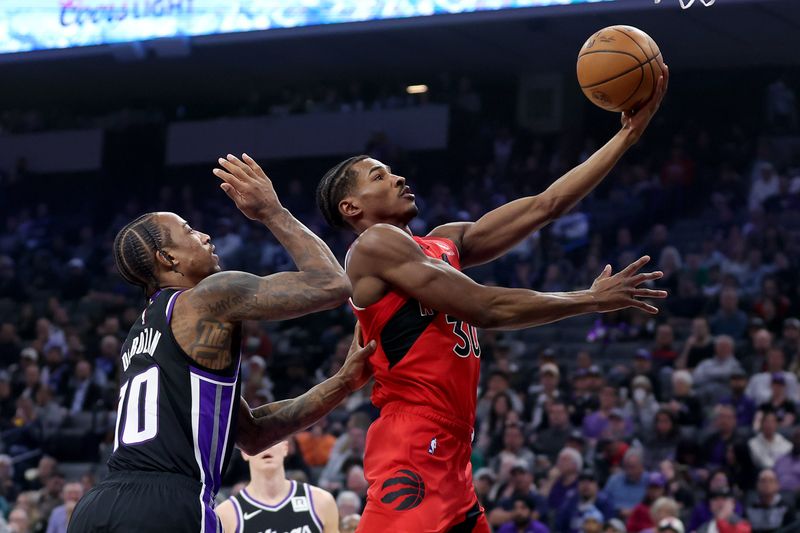 SACRAMENTO, CALIFORNIA - NOVEMBER 06: Ochai Agbaji #30 of the Toronto Raptors goes up for a shot on DeMar DeRozan #10 of the Sacramento Kings in the first half at Golden 1 Center on November 06, 2024 in Sacramento, California. NOTE TO USER: User expressly acknowledges and agrees that, by downloading and/or using this photograph, user is consenting to the terms and conditions of the Getty Images License Agreement.  (Photo by Ezra Shaw/Getty Images)