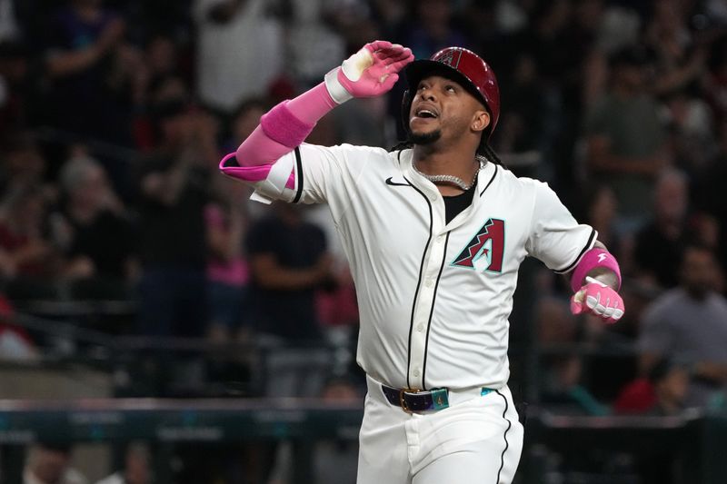 May 18, 2025; Phoenix, Arizona, USA; Arizona Diamondbacks second base Ketel Marte (4) hits a solo home run against the Colorado Rockies in the first inning at Chase Field. Mandatory Credit: Rick Scuteri-Imagn Images