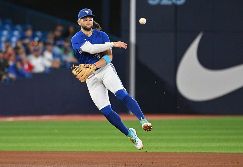 Sep 12, 2023; Toronto, Ontario, CAN;  Toronto Blue Jays shortstop Bo Bichette (11) throws out Texas Rangers left fielder Ezequiel Duran (not pictured) in the fourth inning at Rogers Centre. Mandatory Credit: Dan Hamilton-USA TODAY Sports