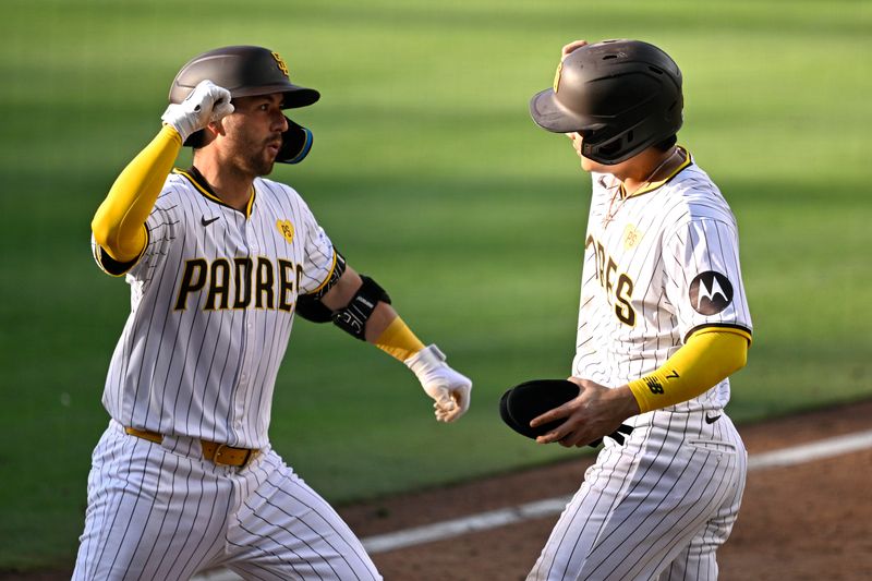 Jun 22, 2024; San Diego, California, USA; San Diego Padres catcher Kyle Higashioka (left) is congratulated by shortstop Ha-Seong Kim (7) after hitting a two-run home run against the Milwaukee Brewers during the seventh inning at Petco Park. Mandatory Credit: Orlando Ramirez-USA TODAY Sports