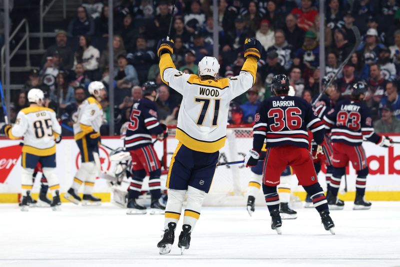 Mar 17, 2026; Winnipeg, Manitoba, CAN; Nashville Predators right wing Matthew Wood (71) celebrates a goal by  left wing Filip Forsberg (9) against the Winnipeg Jets in the second period at Canada Life Centre. Mandatory Credit: James Carey Lauder-Imagn Images