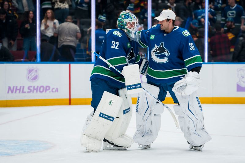 Nov 8, 2025; Vancouver, British Columbia, CAN; Vancouver Canucks goalie Kevin Lankinen (32) and goalie Jiri Patera (30) celebrate their victory against the Columbus Blue Jackets at Rogers Arena. Mandatory Credit: Bob Frid-Imagn Images