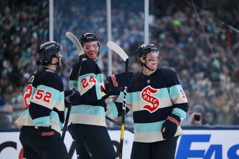 Jan 1, 2024; Seattle, Washington, USA; Seattle Kraken left wing Tye Kartye (52) and defenseman Jamie Oleksiak (24) and defenseman Will Borgen (3) celebrate after Borgen scored a goal against the Vegas Golden Knights during the second period in the 2024 Winter Classic ice hockey game at T-Mobile Park. Mandatory Credit: Steven Bisig-USA TODAY Sports