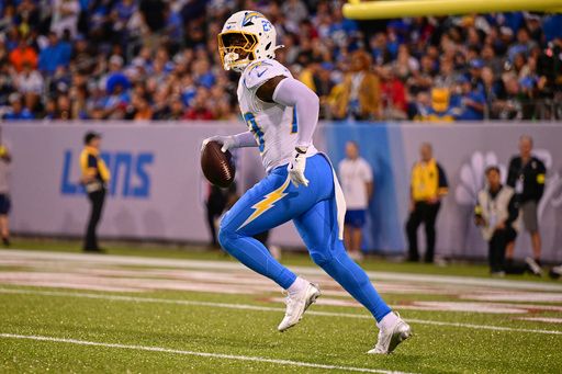 Los Angeles Chargers' Tony Jefferson (23) runs with an interception in the first half of the Pro Football Hall of Fame NFL preseason game against the Detroit Lions, Thursday, July 31, 2025, in Canton, Ohio.(AP Photo/David Dermer)