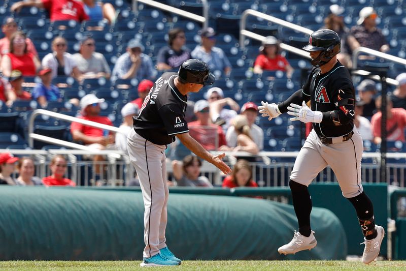 Jun 20, 2024; Washington, District of Columbia, USA; Arizona Diamondbacks first baseman Christian Walker (53) celebrates with Diamondbacks third base coach Tony Perezchica (21) while rounding the bases after hitting a solo home run against the Washington Nationals during the ninth inning at Nationals Park. Mandatory Credit: Geoff Burke-USA TODAY Sports