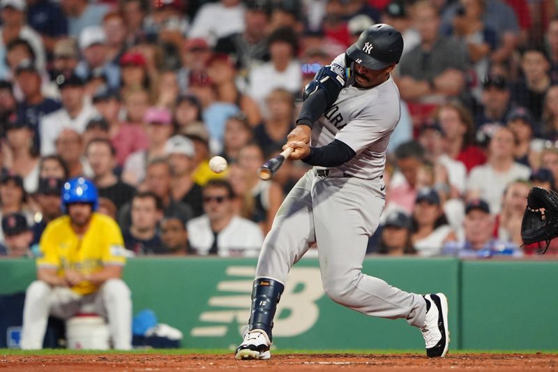 Jul 27, 2024; Boston, Massachusetts, USA; New York Yankees center fielder Trent Grisham (12) hits a single against the Boston Red Sox during the fourth inning at Fenway Park. Mandatory Credit: Gregory Fisher-USA TODAY Sports