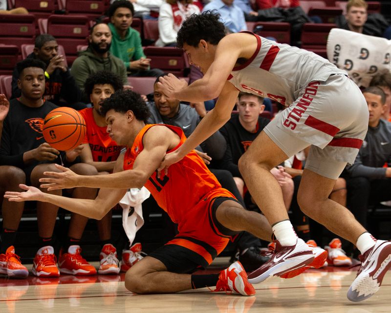 Jan 19, 2023; Stanford, California, USA; Oregon State Beavers forward Michael Rataj (12) and Stanford Cardinal forward Brandon Angel (23) battle for a loose ball during the first half at Maples Pavilion. Mandatory Credit: D. Ross Cameron-USA TODAY Sports