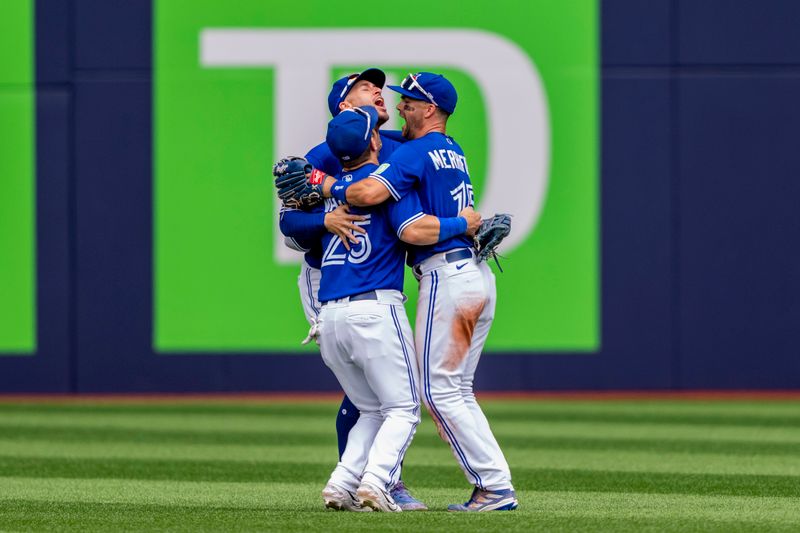 Aug 13, 2023; Toronto, Ontario, CAN; Toronto Blue Jays second baseman Whit Merrifield (15) celebrates with teammates right fielder George Springer (4), and left fielder Daulton Varsho (25) after defeating the Chicago Cubs at Rogers Centre. Mandatory Credit: Kevin Sousa-USA TODAY Sports