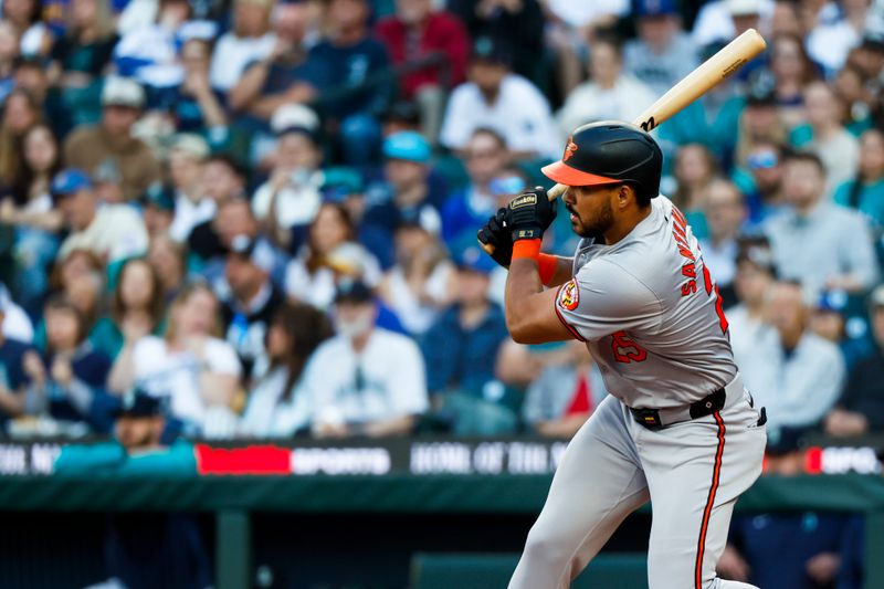 Jul 2, 2024; Seattle, Washington, USA; Baltimore Orioles right fielder Anthony Santander (25) hits an RBI-single against the Seattle Mariners during the fourth inning at T-Mobile Park. Mandatory Credit: Joe Nicholson-USA TODAY Sports