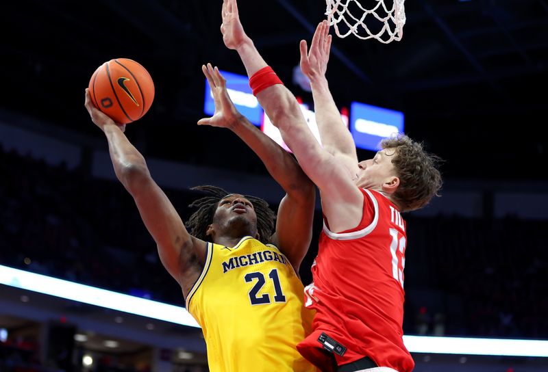Feb 8, 2026; Columbus, Ohio, USA;  Michigan Wolverines forward Morez Johnson Jr. (21) drives to the basket as Ohio State Buckeyes center Christoph Tilly (13) defends during the first half at Value City Arena. Mandatory Credit: Joseph Maiorana-Imagn Images