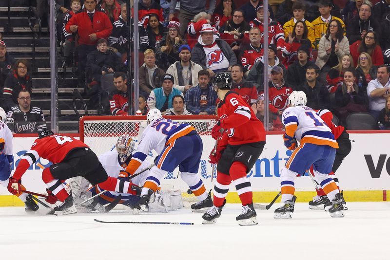 Nov 28, 2023; Newark, New Jersey, USA; New Jersey Devils center Curtis Lazar (42) scores a goal on New York Islanders goaltender Ilya Sorokin (30) during the third period at Prudential Center. Mandatory Credit: Ed Mulholland-USA TODAY Sports