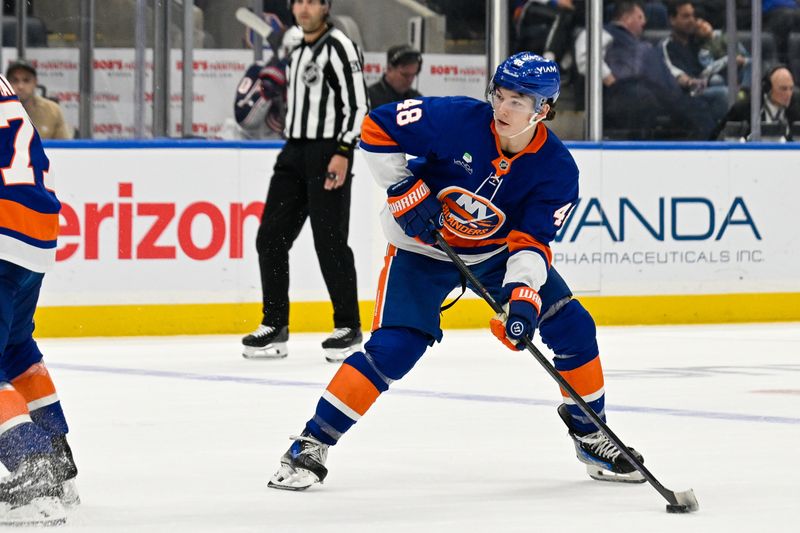 Nov 2, 2025; Elmont, New York, USA; New York Islanders defenseman Matthew Schaefer (48) skates with the puck against the Columbus Blue Jackets during the third period at UBS Arena. Mandatory Credit: Dennis Schneidler-Imagn Images