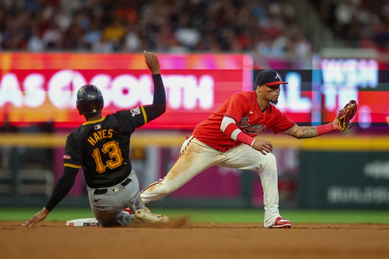 Jun 28, 2024; Atlanta, Georgia, USA; Atlanta Braves shortstop Orlando Arcia (11) forces out Pittsburgh Pirates third baseman Ke'Bryan Hayes (13) in the fifth inning at Truist Park. Mandatory Credit: Brett Davis-USA TODAY Sports
