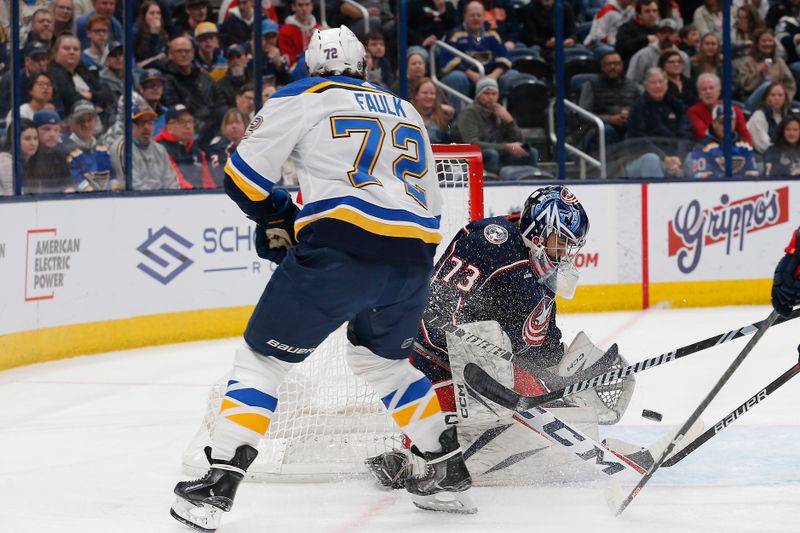 Dec 8, 2023; Columbus, Ohio, USA; Columbus Blue Jackets goalie Jet Greaves (73) makes a save as St. Louis Blues defenseman Justin Faulk (72) looks for a rebound during the first period at Nationwide Arena. Mandatory Credit: Russell LaBounty-USA TODAY Sports