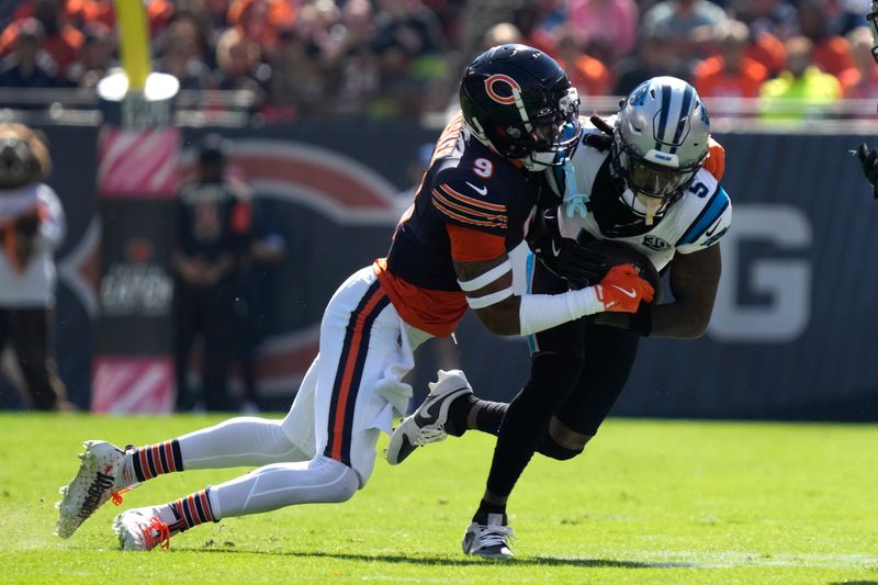 Chicago Bears safety Jaquan Brisker (9) tackles Carolina Panthers wide receiver Diontae Johnson (5) during the first half of an NFL football game Sunday, Oct. 6, 2024, in Chicago. (AP Photo/Nam Y. Huh)