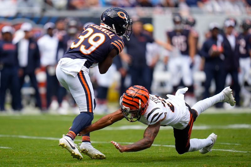 Cincinnati Bengals cornerback DJ Turner II (20) fails to tackle Chicago Bears cornerback Josh Blackwell (39) during the first half of an NFL preseason football game, Saturday, Aug. 17, 2024, at Soldier Field in Chicago. (AP Photo/Erin Hooley)