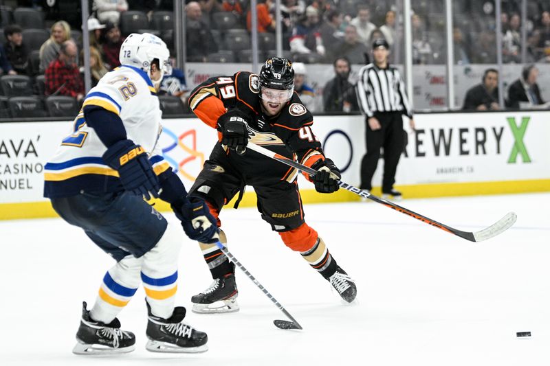 Mar 25, 2023; Anaheim, California, USA; Anaheim Ducks left wing Max Jones (49) passes the puck in front of St. Louis Blues defenseman Justin Faulk (72) during the third period at Honda Center. Mandatory Credit: Kelvin Kuo-USA TODAY Sports