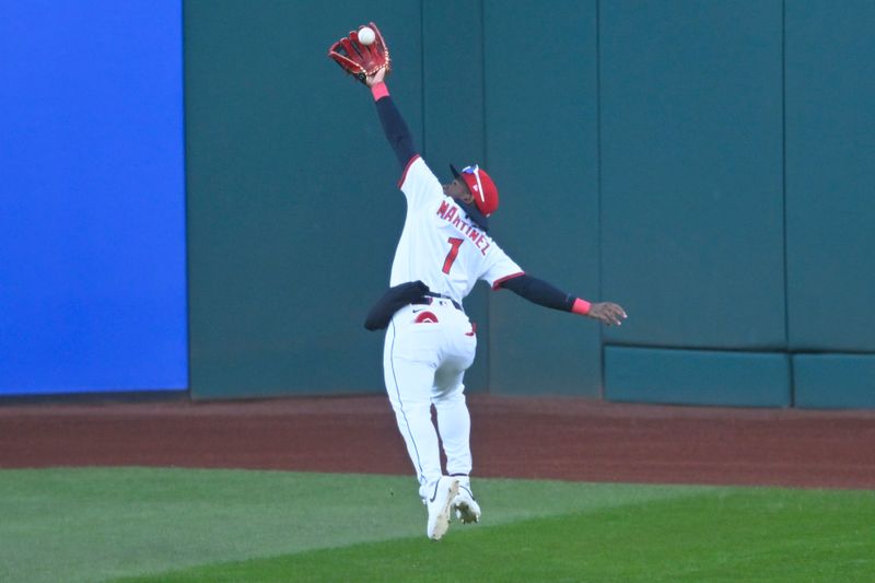 Apr 12, 2025; Cleveland, Ohio, USA; Cleveland Guardians center fielder Angel Martinez (1) makes a running catch in the second inning against the Kansas City Royals at Progressive Field. Mandatory Credit: David Richard-Imagn Images