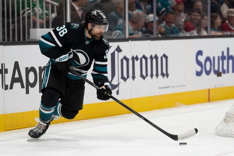 Mar 3, 2026; San Jose, California, USA;  San Jose Sharks defenseman Mario Ferraro (38) controls the puck during the first period against the Montreal Canadiens at SAP Center at San Jose. Mandatory Credit: Stan Szeto-Imagn Images