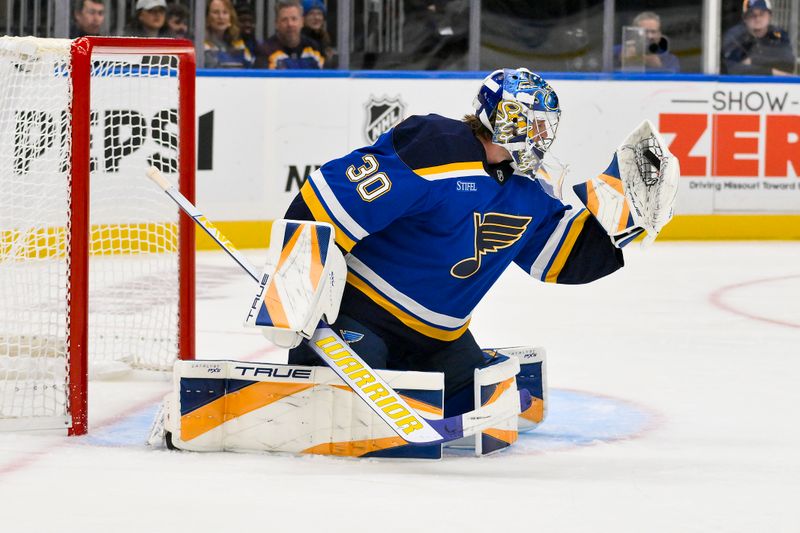 Oct 1, 2024; St. Louis, Missouri, USA;  St. Louis Blues goaltender Joel Hofer (30) defends the net against the Columbus Blue Jackets during the first period at Enterprise Center. Mandatory Credit: Jeff Curry-Imagn Images