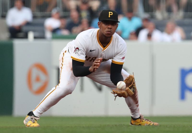 Jun 4, 2025; Pittsburgh, Pennsylvania, USA;  Pittsburgh Pirates third baseman Ke'Bryan Hayes (13) fields a ground ball for an out against Houston Astros right fielder Cam Smith (not pictured) during the fifth inning at PNC Park. Mandatory Credit: Charles LeClaire-Imagn Images