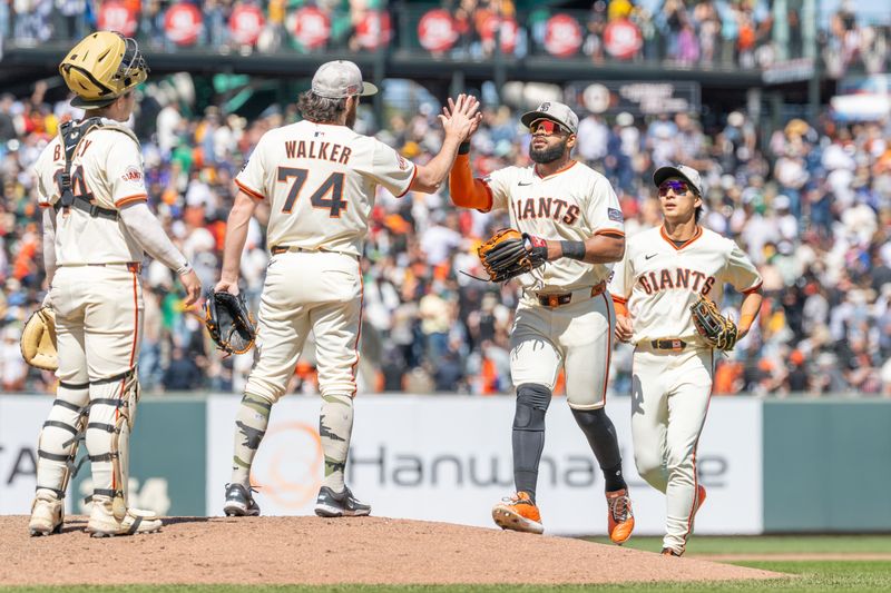 May 18, 2025; San Francisco, California, USA; San Francisco Giants outfielder Heliot Ramos (17) gives a high-five to San Francisco Giants pitcher Ryan Walker (74) after the game against the Oakland Athletics at Oracle Park. Mandatory Credit: Bob Kupbens-Imagn Images