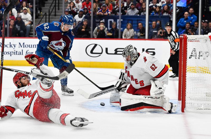 Oct 21, 2023; Denver, Colorado, USA; Carolina Hurricanes goaltender Pyotr Kochetkov (52) makes a save as Colorado Avalanche left wing Artturi Lehkonen (62) watches the puck in the second period at Ball Arena. Mandatory Credit: John Leyba-USA TODAY Sports