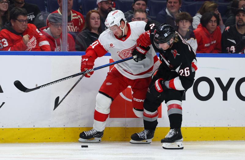 Oct 26, 2024; Buffalo, New York, USA;  Detroit Red Wings right wing Vladimir Tarasenko (11) and Buffalo Sabres defenseman Rasmus Dahlin (26) go after a loose puck during the third period at KeyBank Center. Mandatory Credit: Timothy T. Ludwig-Imagn Images