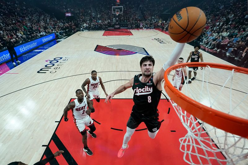 PORTLAND, OREGON - JANUARY 11: Deni Avdija #8 of the Portland Trail Blazers dunks the ball during the first half against the Miami Heat at Moda Center on January 11, 2025 in Portland, Oregon. NOTE TO USER: User expressly acknowledges and agrees that, by downloading and or using this photograph, User is consenting to the terms and conditions of the Getty Images License Agreement. (Photo by Soobum Im/Getty Images)