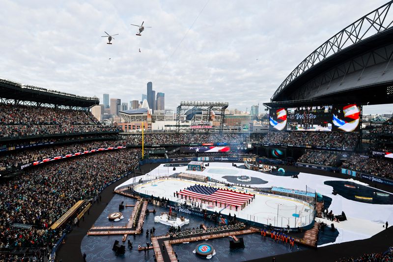 Jan 1, 2024; Seattle, Washington, USA; U.S. Coast Guard helicopters perform a flyover during the national anthem before the first period in the 2024 Winter Classic ice hockey game between the Vegas Golden Knights and Seattle Kraken at T-Mobile Park. Mandatory Credit: Joe Nicholson-USA TODAY Sports