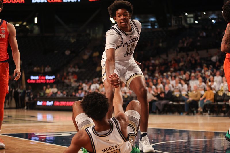 Jan 14, 2025; Atlanta, Georgia, USA; Georgia Tech Yellow Jackets center Ryan Mutombo (12) helps up teammate guard Jaeden Mustaf (3) in the game against the Clemson Tigers during the first half at McCamish Pavilion. Mandatory Credit: Jordan Godfree-Imagn Images