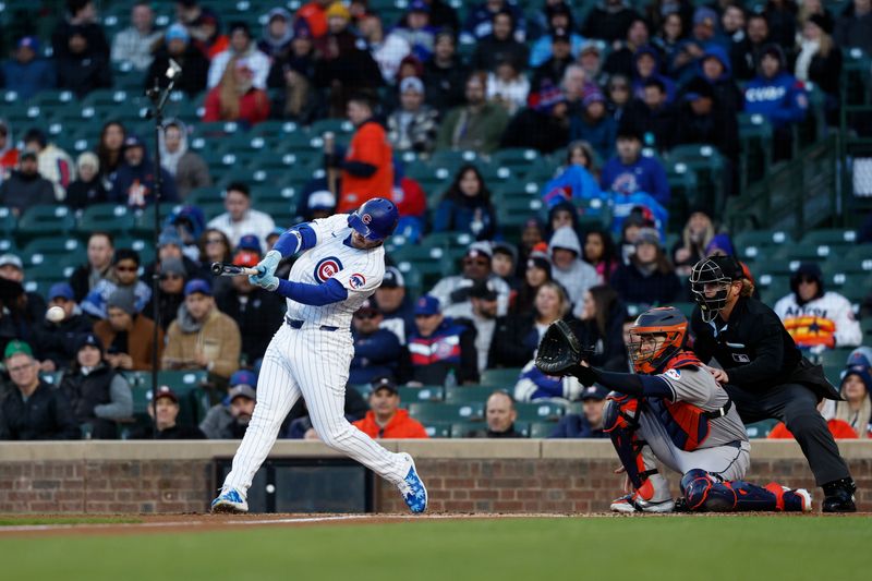 Apr 24, 2024; Chicago, Illinois, USA; Chicago Cubs outfielder Ian Happ (8) singles against the Houston Astros during the first inning at Wrigley Field. Mandatory Credit: Kamil Krzaczynski-USA TODAY Sports