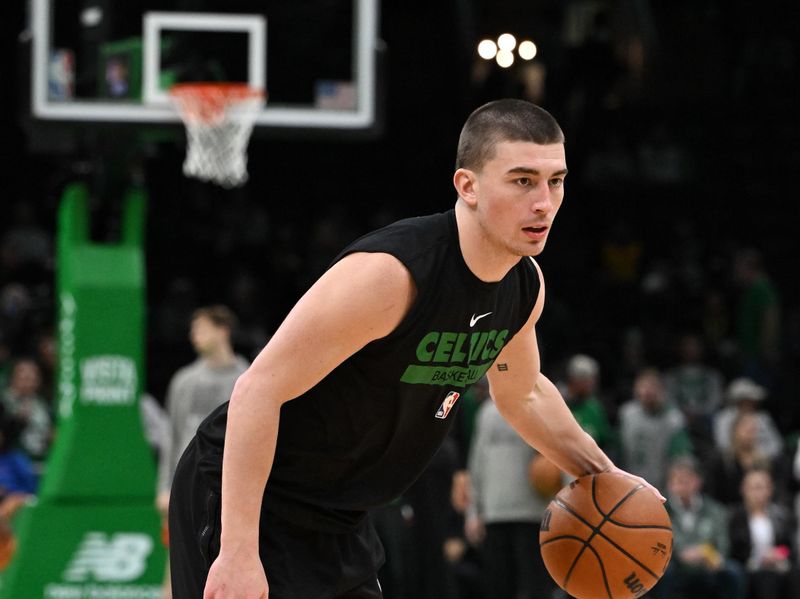 BOSTON, MASSACHUSETTS - JANUARY 13: Payton Pritchard #11 of the Boston Celtics dribbles the ball during wamrups before a game against the Houston Rockets at the TD Garden on January 13, 2024 in Boston, Massachusetts. NOTE TO USER: User expressly acknowledges and agrees that, by downloading and or using this photograph, User is consenting to the terms and conditions of the Getty Images License Agreement. (Photo by Brian Fluharty/Getty Images)