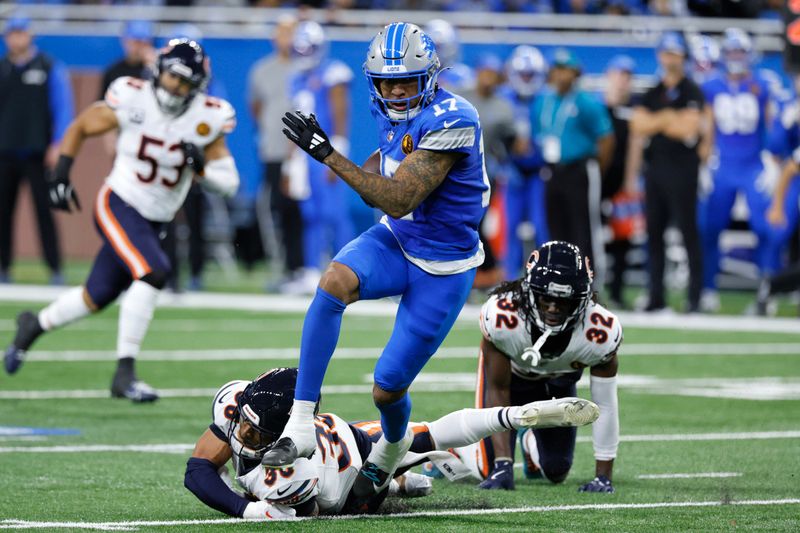 Detroit Lions wide receiver Tim Patrick (17) escapes the tackle of Chicago Bears safety Jonathan Owens (36) during the first half of an NFL football game, Sunday, Nov. 17, 2024, in Detroit. (AP Photo/Duane Burleson)