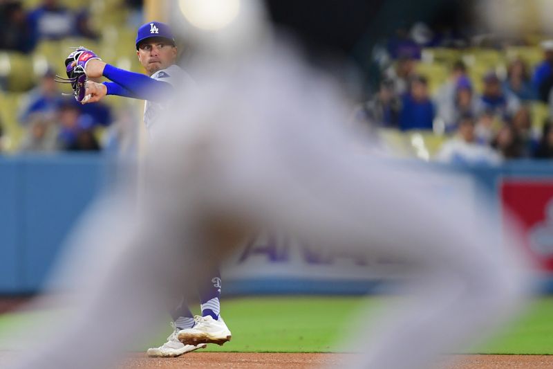 May 22, 2024; Los Angeles, California, USA; Los Angeles Dodgers third baseman Enrique Hernandez (8) throws to first for the out against Arizona Diamondbacks shortstop Blaze Alexander (9) during the eighth inning at Dodger Stadium. Mandatory Credit: Gary A. Vasquez-USA TODAY Sports